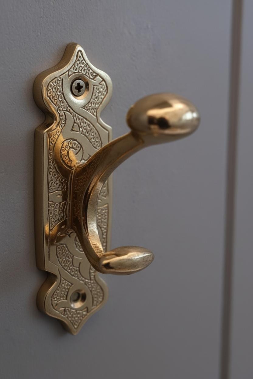 Decorative gold door handle on a gray door