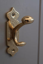 Decorative gold door handle on a gray door