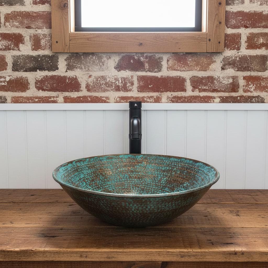 Decorative glass sink on a wooden countertop with a brick wall background