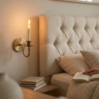 Handmade brass candle holder wall light creating warm ambient lighting for modern home decor