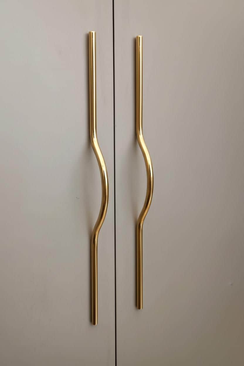 Gold cabinet handles on a light gray door