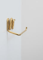 Gold metal hook on a white background