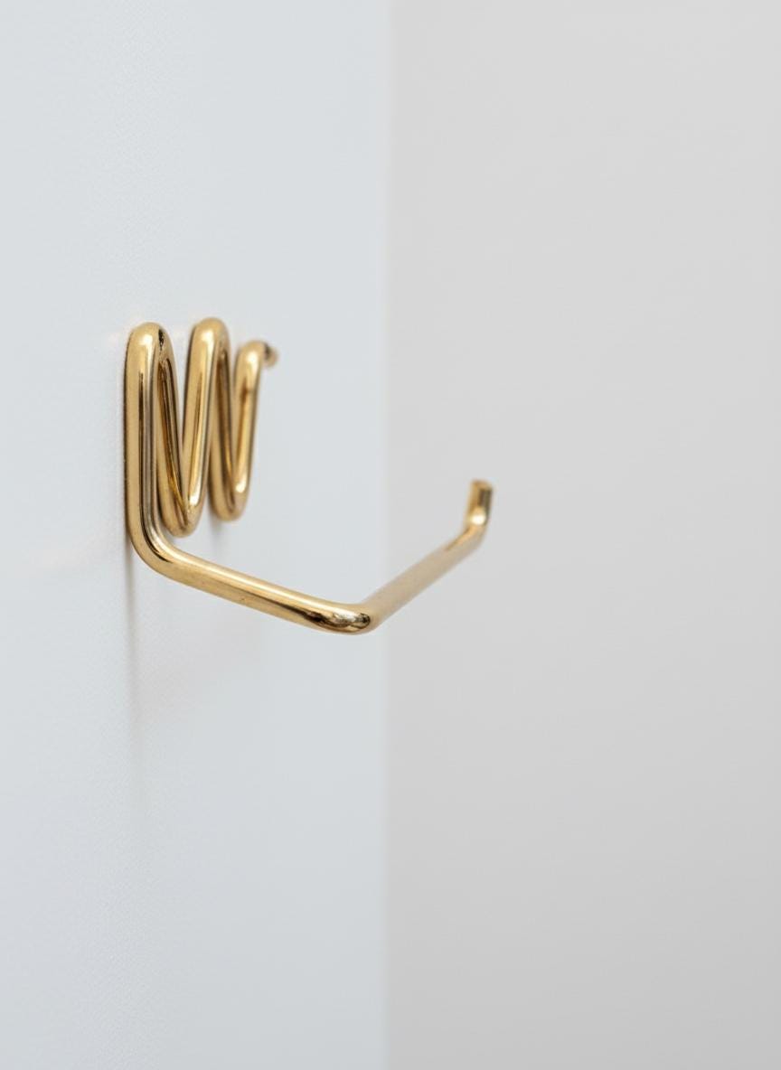 Gold metal hook on a white background