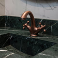 Bronze faucet on a marble sink