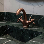 Bronze faucet on a marble sink