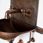 Vintage-style copper sink with faucet on a white background
