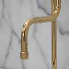 Gold faucet handle on a marble background