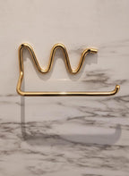 Gold crown-shaped holder on a marble surface