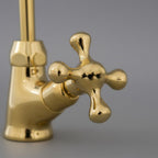 Gold faucet on a gray background