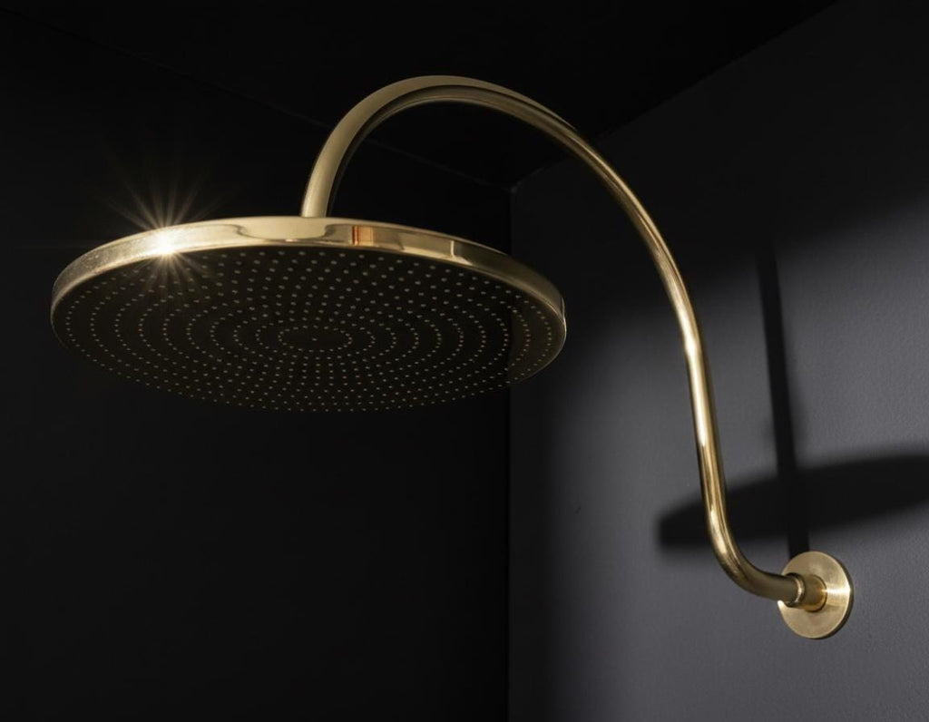 Unlacquered solid brass gooseneck shower arm with round rainfall showerhead for a luxurious bathroom finish
