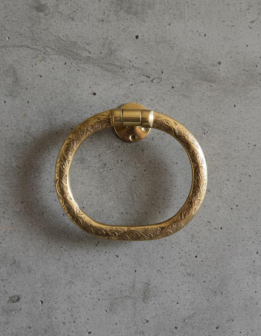 Decorative gold door handle on a concrete surface