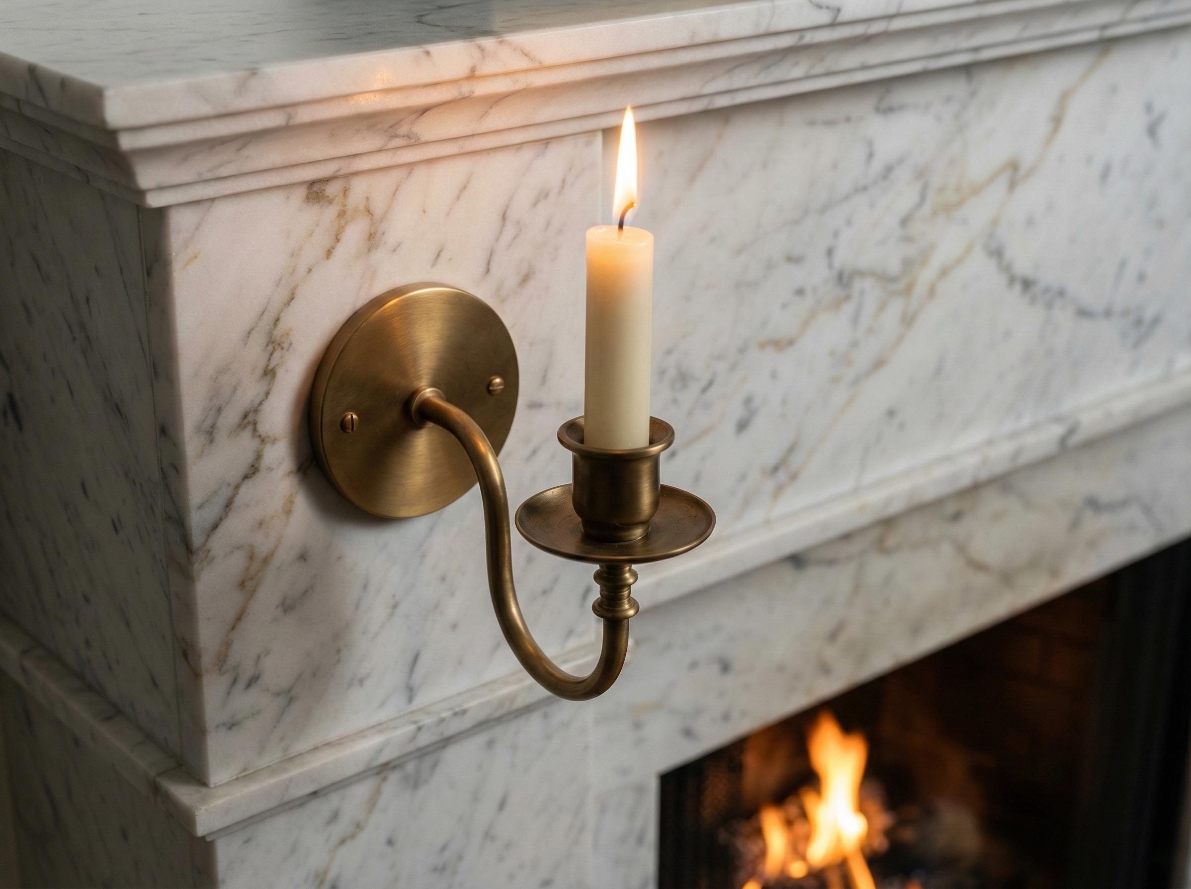 Handmade brass candle holder wall light creating warm ambient lighting for modern home decor