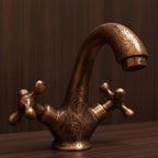 Bronze faucet with intricate designs on a wooden surface
