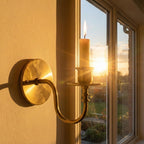 Handmade brass candle holder wall light creating warm ambient lighting for modern home decor