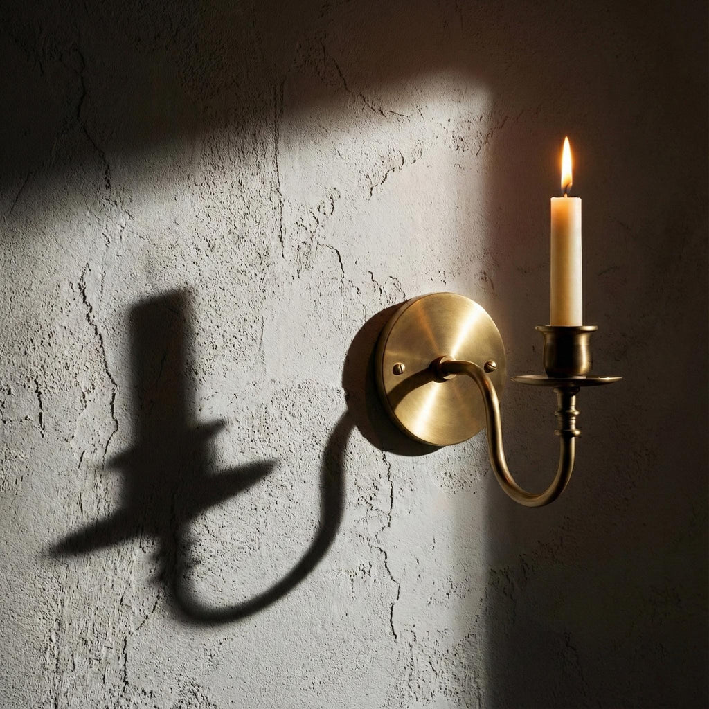 Handmade brass candle holder wall light creating warm ambient lighting for modern home decor